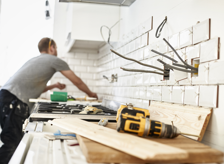 image if man tiling kitchen splash back